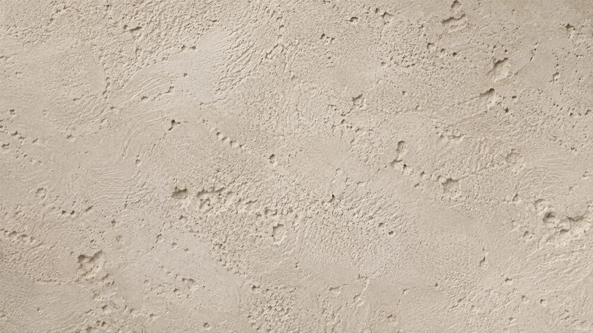 A wall finished in a textured hand-applied lime plaster